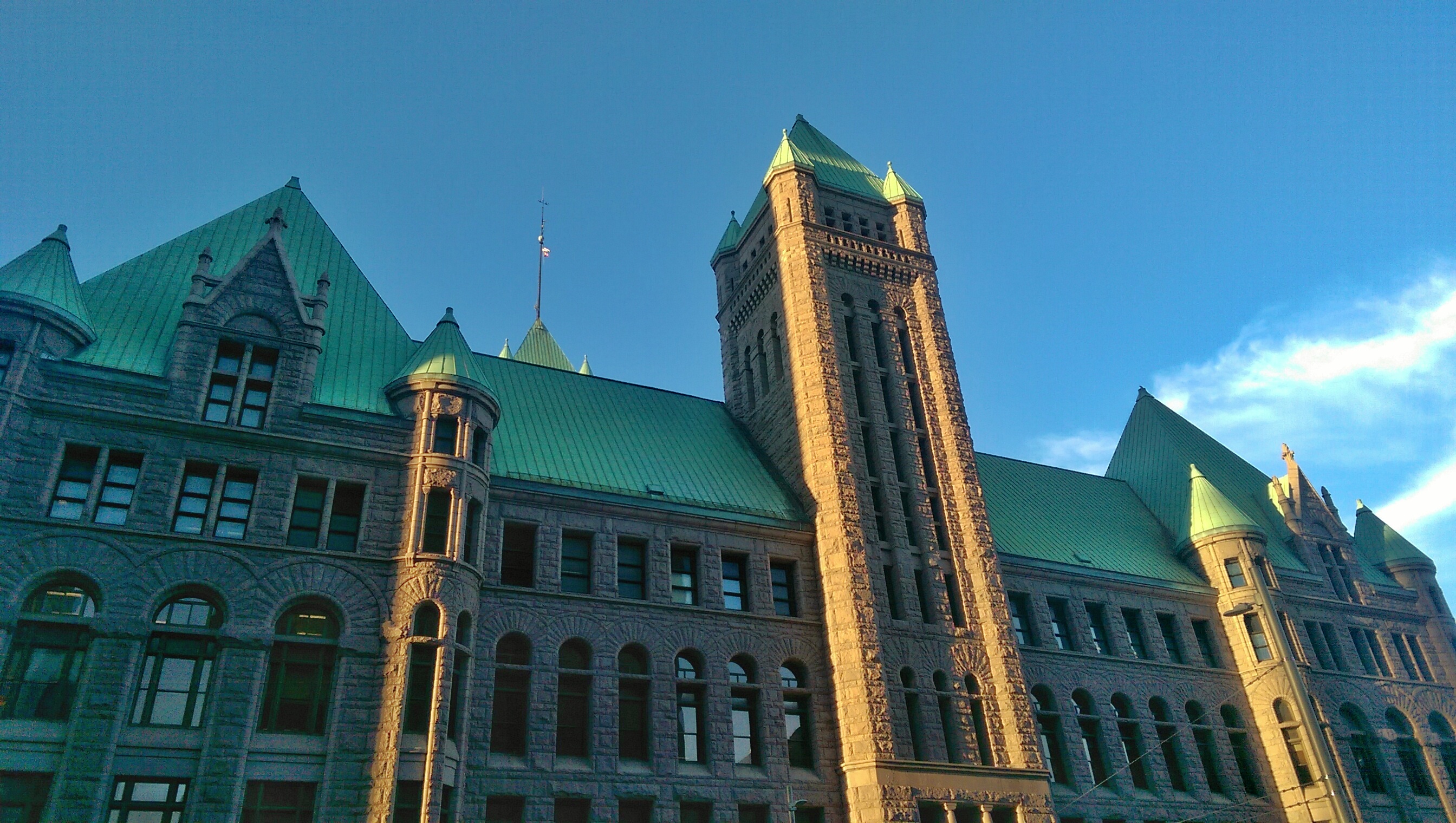 Exterior of Minneapolis City Hall. A brown building with a clock tower.