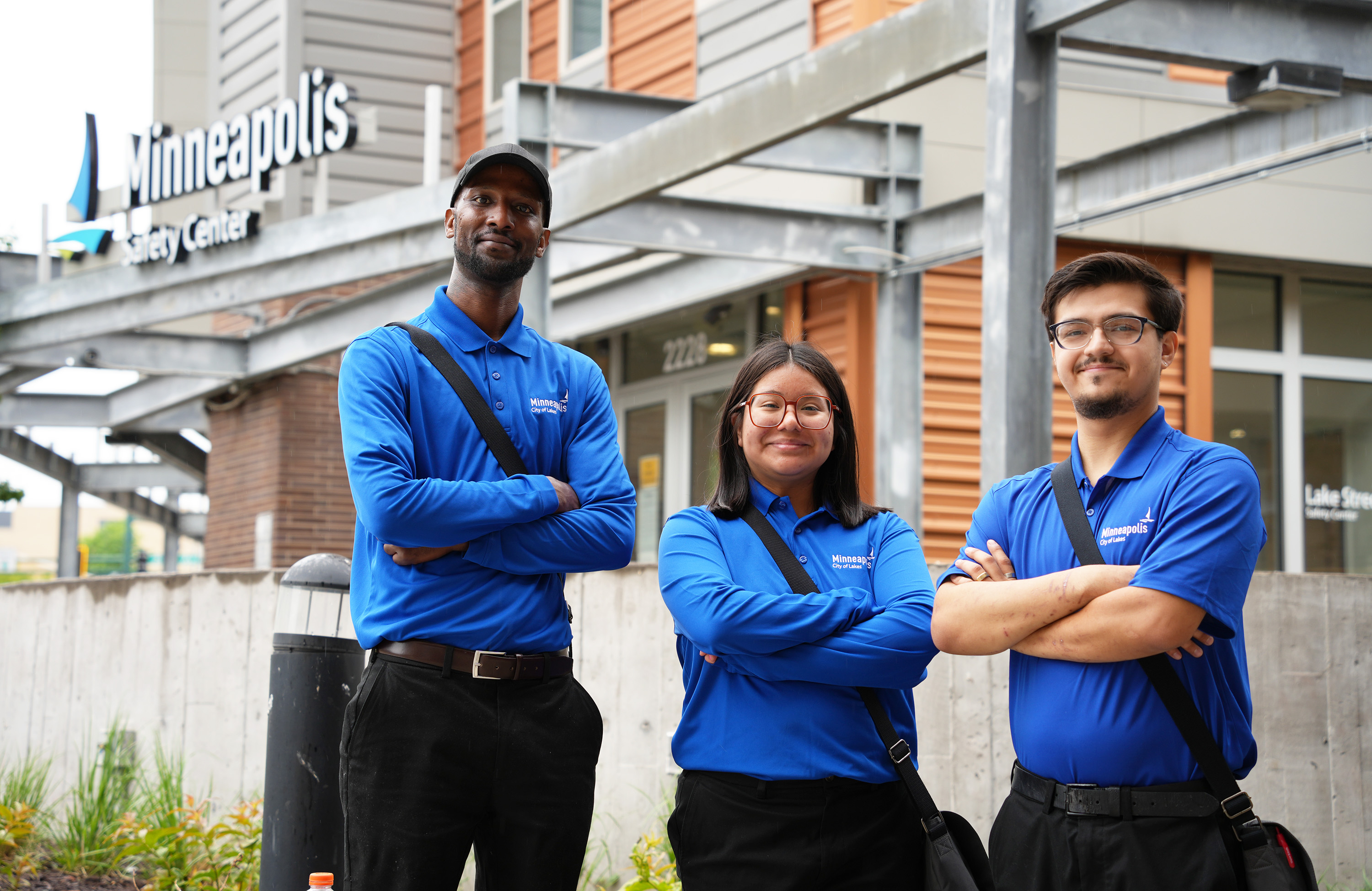 Three safety ambassadors standing in front of the Lake Street Safety Center