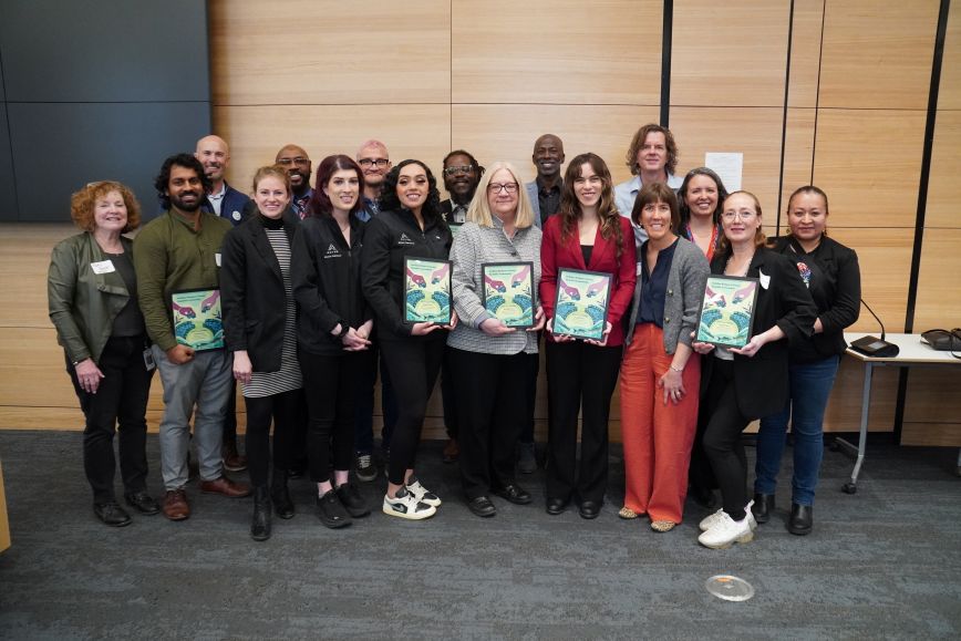 group of people holding awards