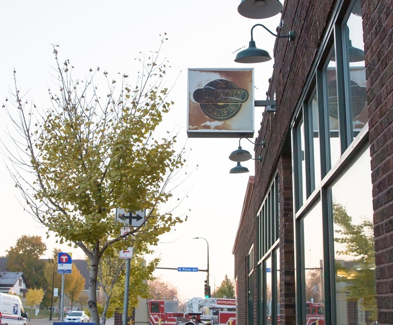 Lowry Avenue business with tree outside. Photo courtesy of Meet Minneapolis.