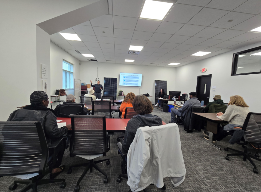 People in a training session listening to a speaker