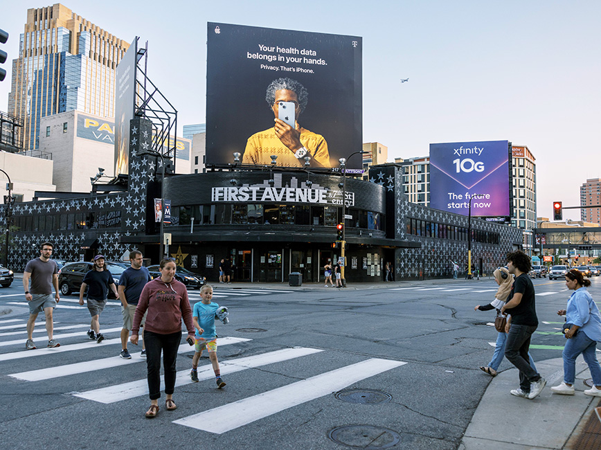 People crossing the street in front of First Avenue