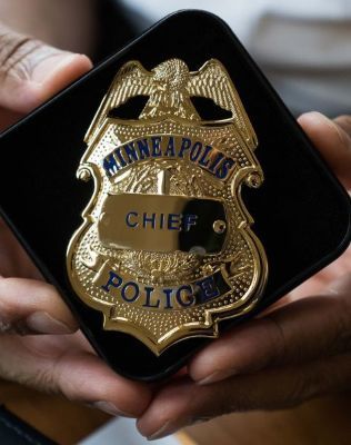 Picture of hands holding a police chief badge