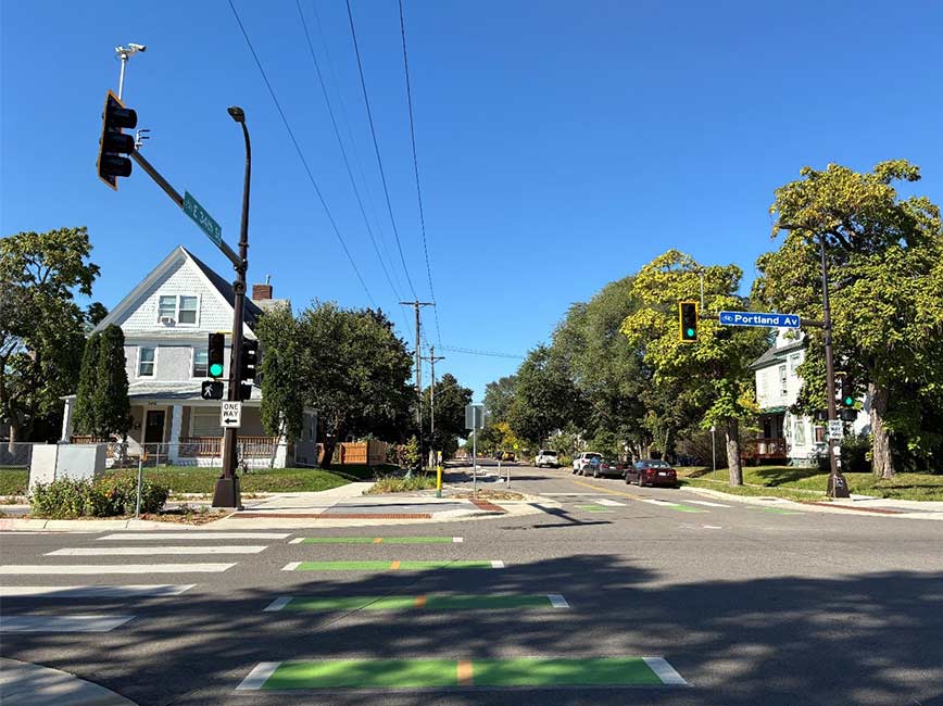 Intersection with bikeway markings and housing on the corner
