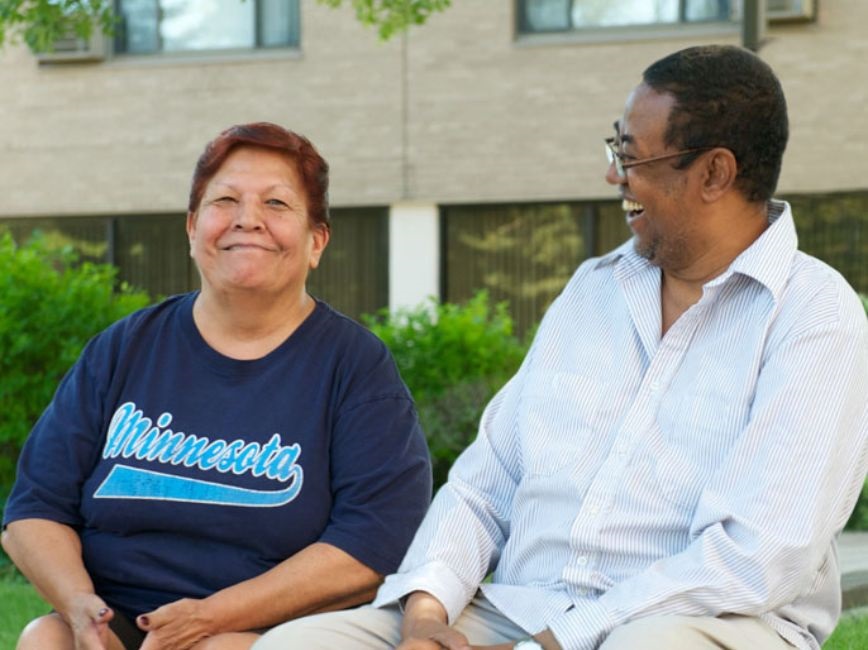 Two adults smiling together