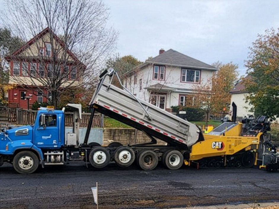 Photo of City staff resurfacing pavement