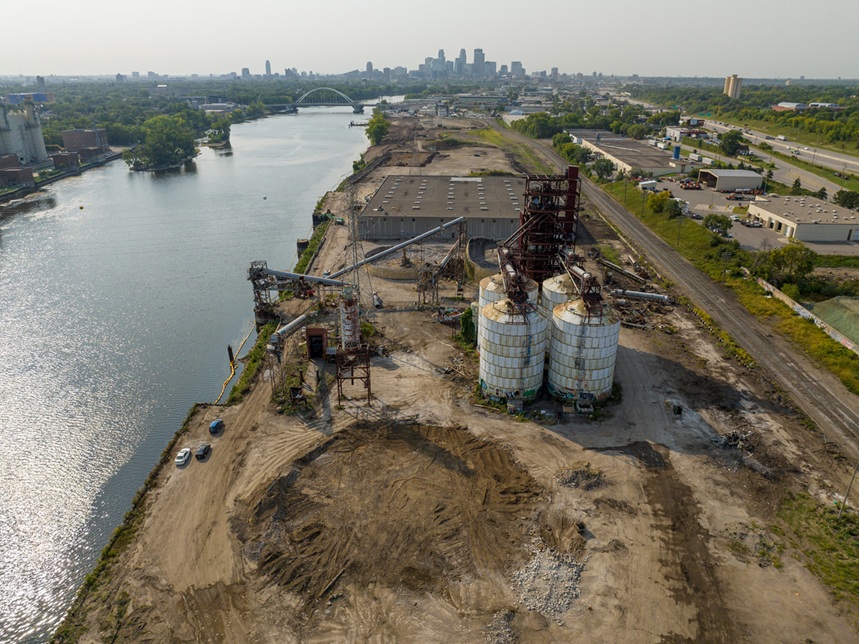 Upper Harbor site demolition with view of Mississippi River and Minneapolis skyline