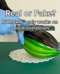 Gloved hands cutting into football with a knife. Text at the top of the image says 