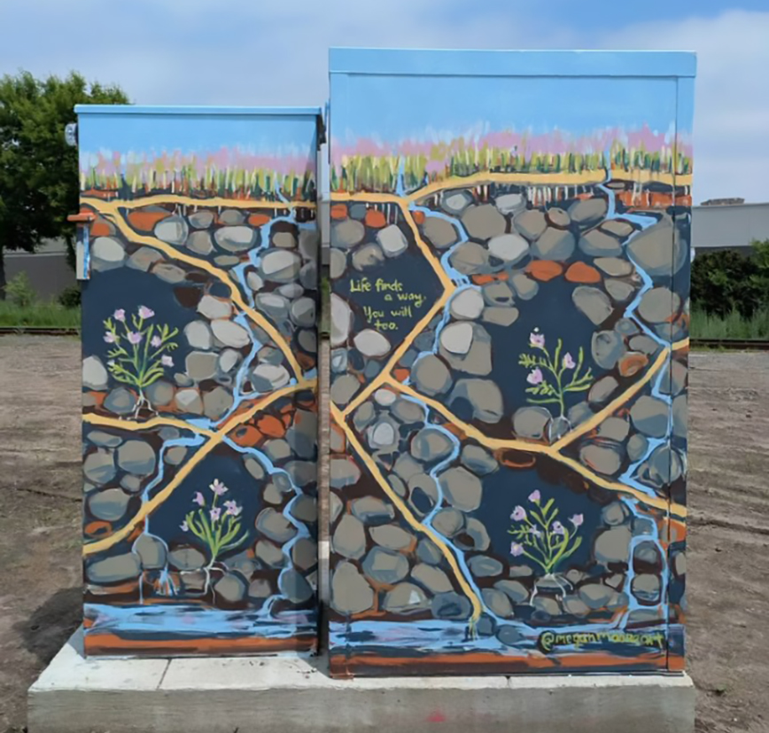Two utility boxes painted with plant roots.