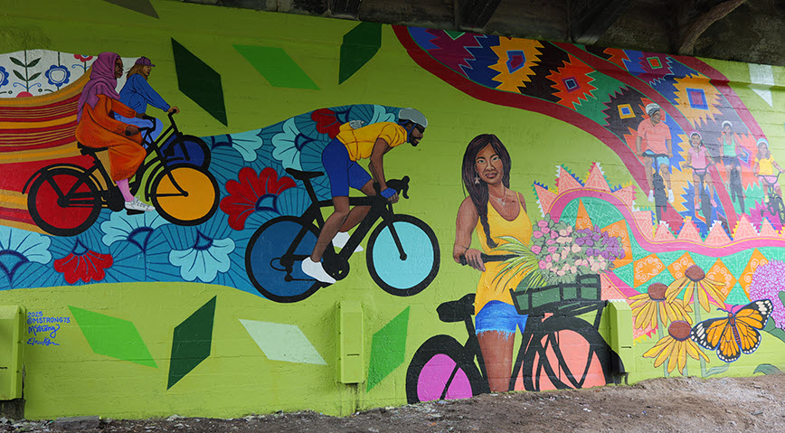 Colorful mural featuring woman and bicycle.