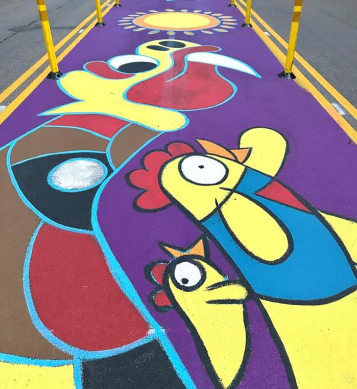 Color mural painted on a street featuring a chicken.