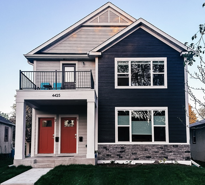 Duplex home with a patio above the front doors