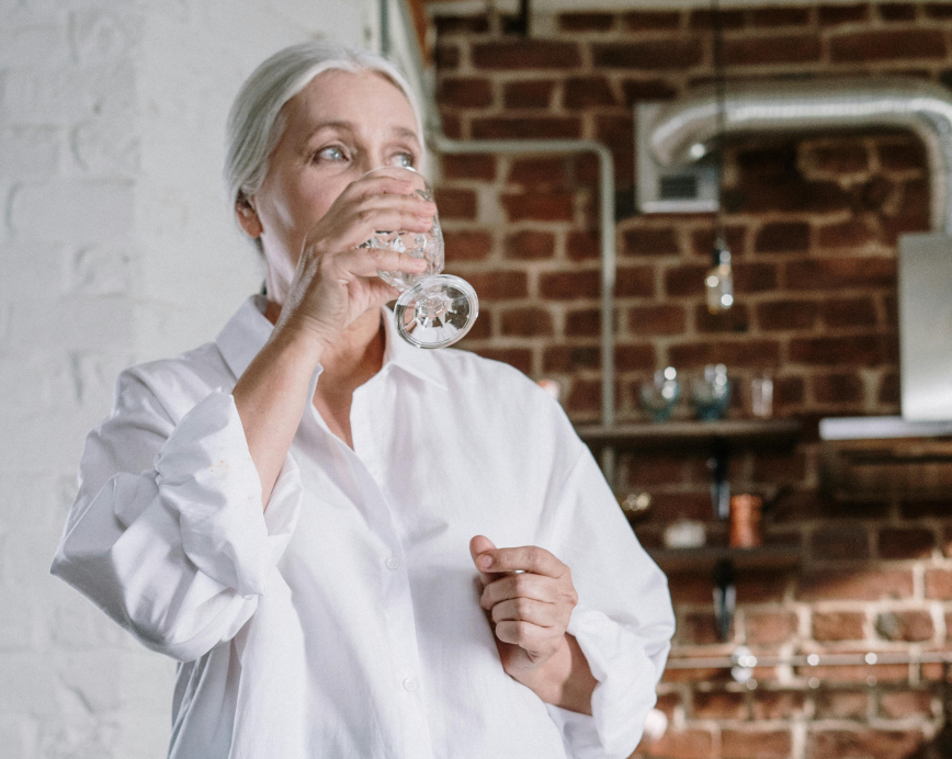 Person drinking a glass of water