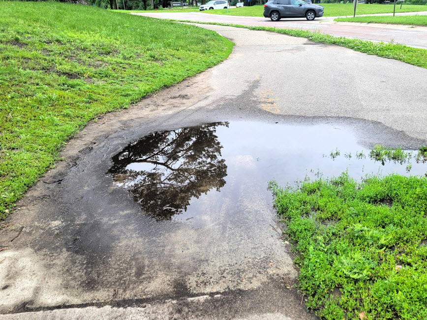Sidewalk with water puddle near Minnehaha park