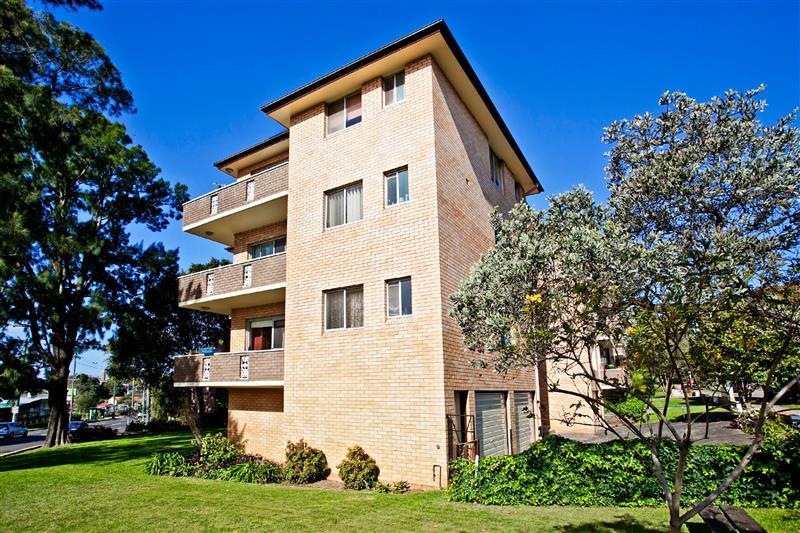Small apartment building with three levels and a garage