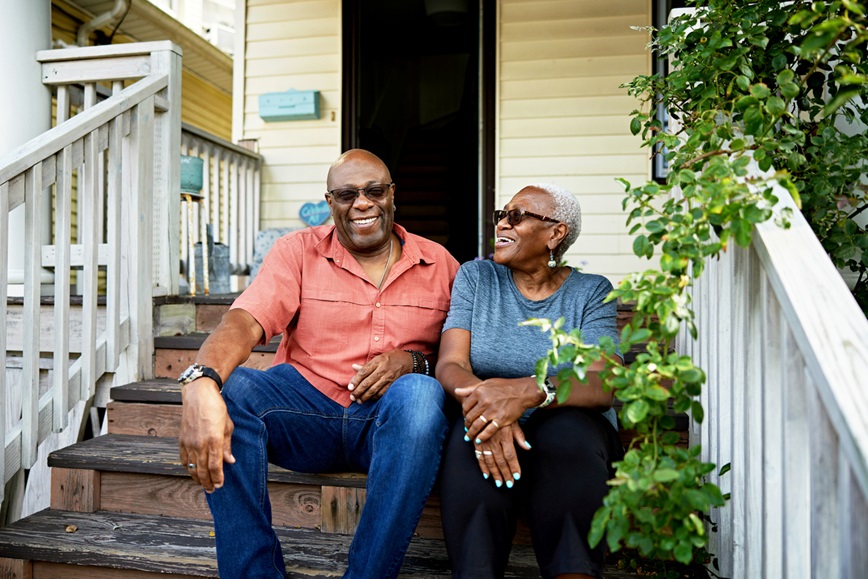 Two adults on front steps of house