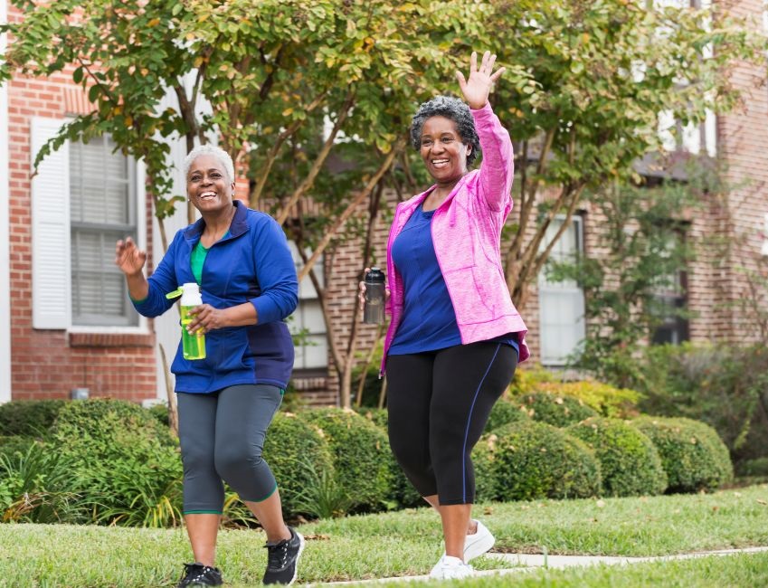 Two senior adults walking and smiling