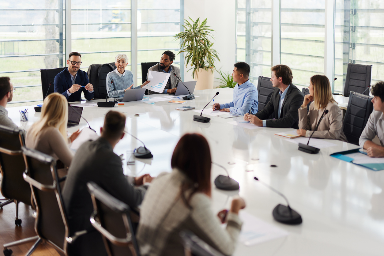 People sitting at a conference table having a meeting.