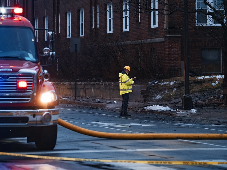 A Minneapolis fire inspector in front of a building