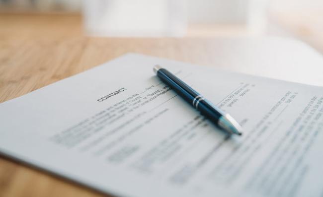 Pen resting on contract document