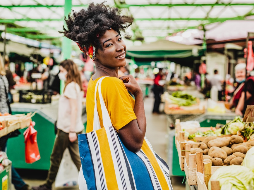 Farmers market vendor selling vegetables