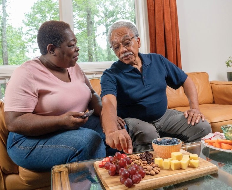 Two adults eating healthy food