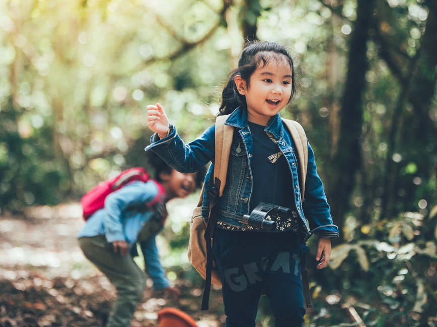 Two smiling children outside