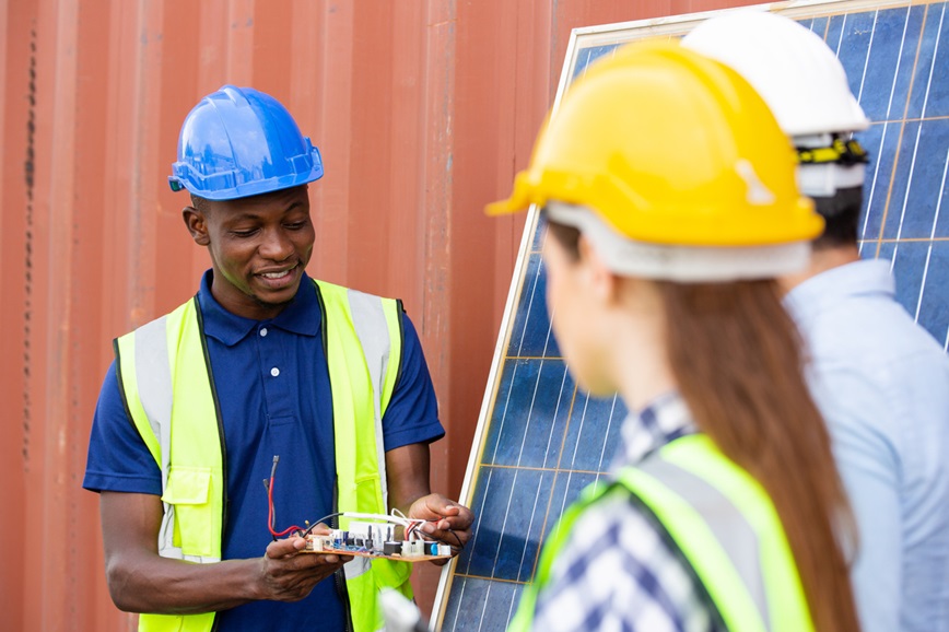 Teenager and coworker talking about solar panels