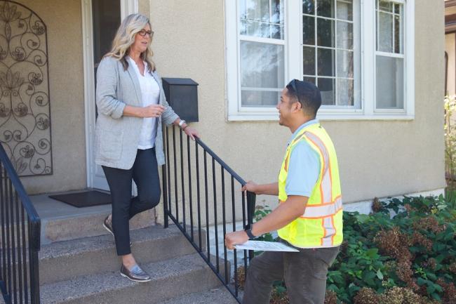 two people talking in front of home