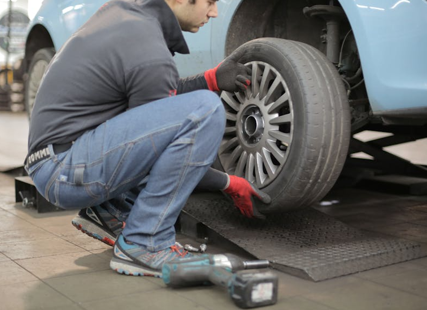 Person repairing a car.