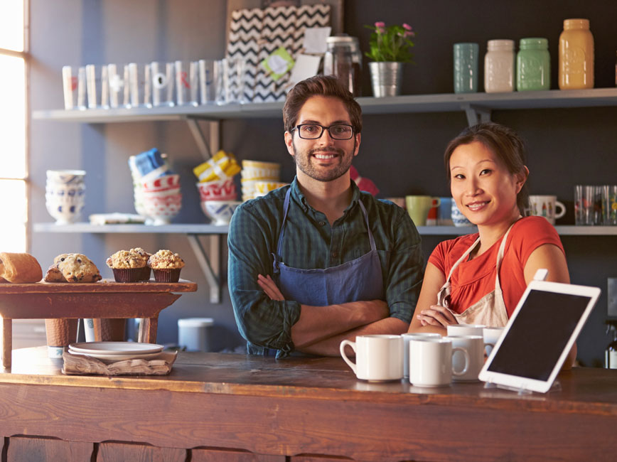 Two people behind a counter in a store