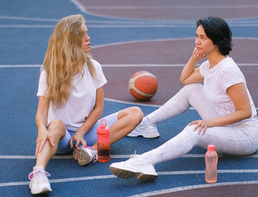 Person holding basketball on waist under their arm