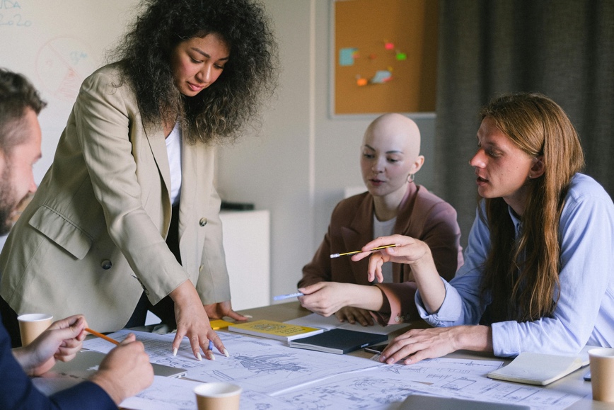 Diverse team reviewing blueprints