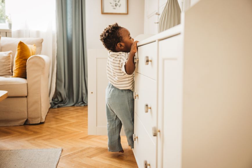 toddler leaning on counter