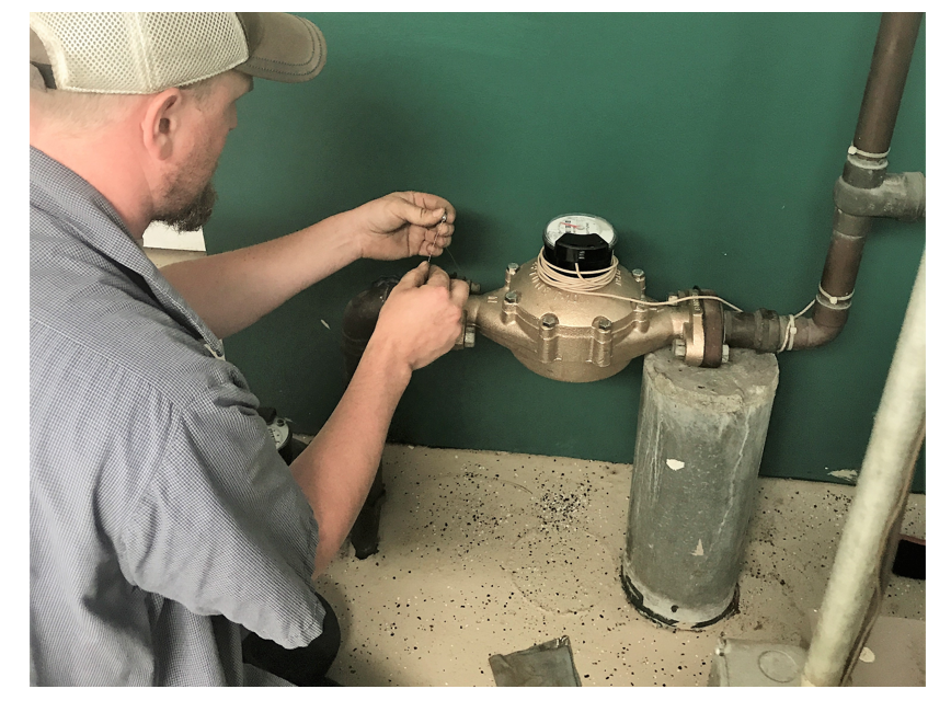 Water Distribution Operator checking water meter