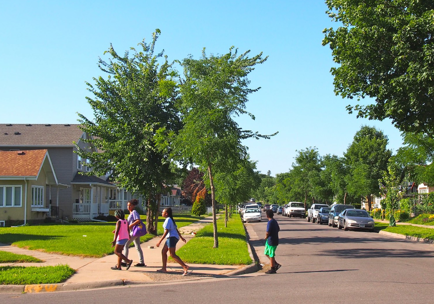 Children walking across the street in a neighborhood in Minneapolis
